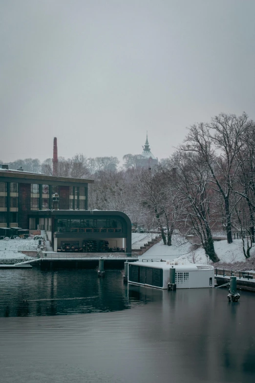 a body of water surrounded by snow covered trees, a matte painting, by Jesper Myrfors, pexels contest winner, modernism, stockholm city portrait, gloomy library, ground level view of soviet town, today\'s featured photograph 4k