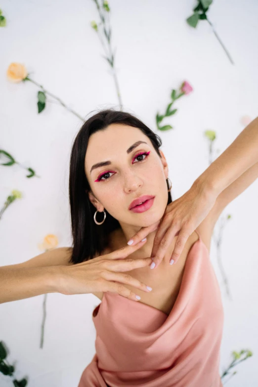 a woman in a pink dress posing for a picture, an album cover, by Julia Pishtar, trending on pexels, antipodeans, hands on face, irelia, armpit, enes dirig