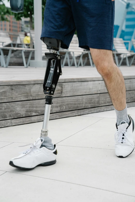 a man with a prosthetic device on his leg, unsplash, gray shorts and black socks, pixelated, exoskeletton, tall