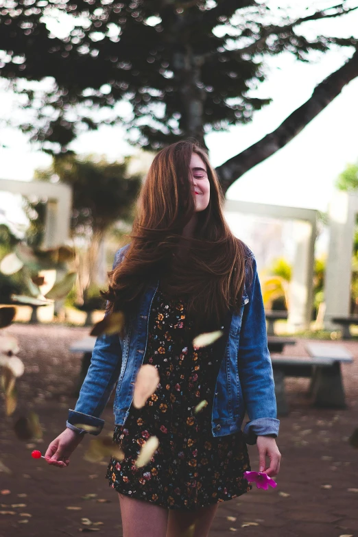 a woman in a floral dress and denim jacket, pexels contest winner, brown flowing hair, wearing jeans and a black hoodie, 2019 trending photo