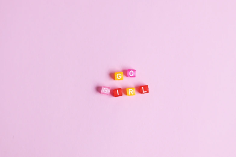 the word love spelled with cubes on a pink background, by Olivia Peguero, feminist art, we go, mini figure, 19-year-old girl, for gq