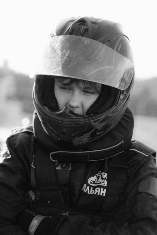 a black and white photo of a person wearing a helmet, a black and white photo, flickr, realism, tomboy, turbo, profile pic, kid