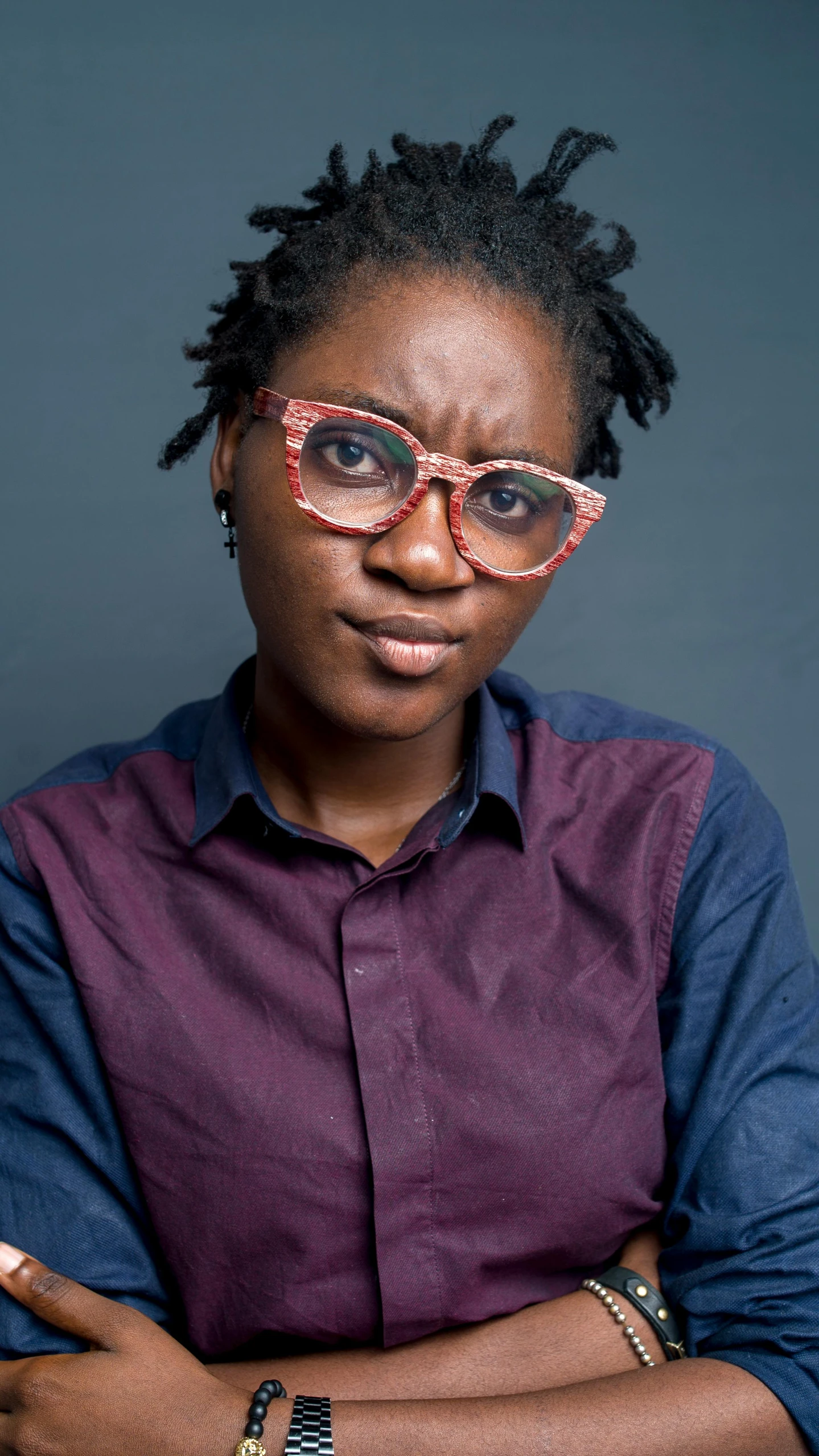 a woman with glasses posing for a picture, an album cover, by Chinwe Chukwuogo-Roy, pexels, stern expression, press photo, loosely cropped, portrait n - 9