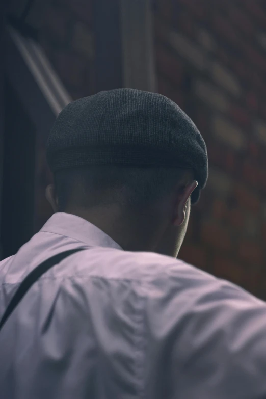 a close up of a person wearing a hat, inspired by Bert Hardy, happening, back of the hair, peaky blinders gang, bald head, looking around a corner