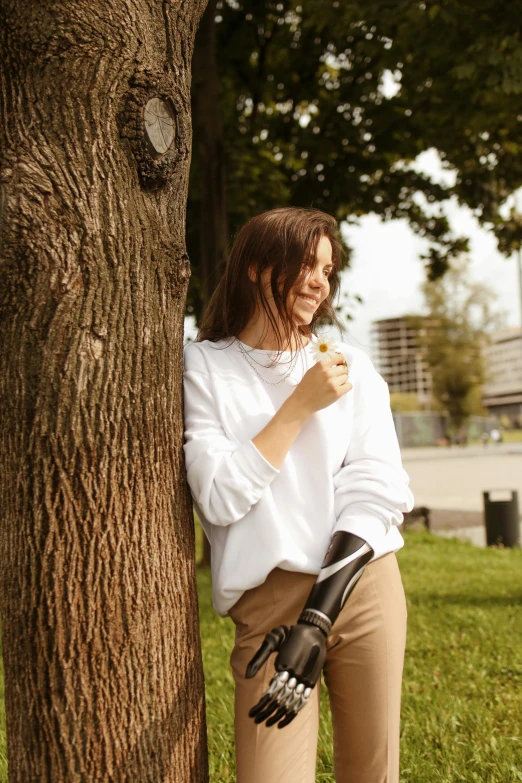 a woman leaning against a tree in a park, by Niko Henrichon, happening, wearing sweatshirt, casual white garment, eating, profile image