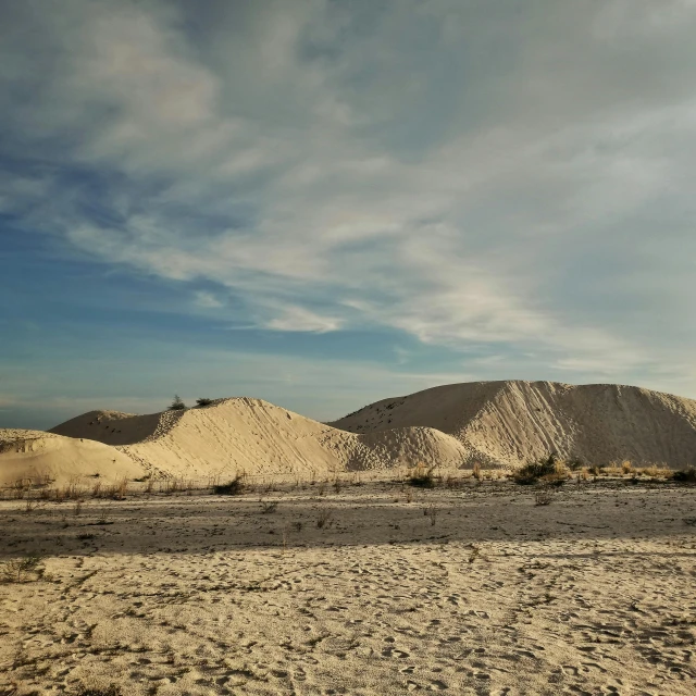 a large pile of sand sitting in the middle of a desert, white beaches, skies, bay area, múseca illil