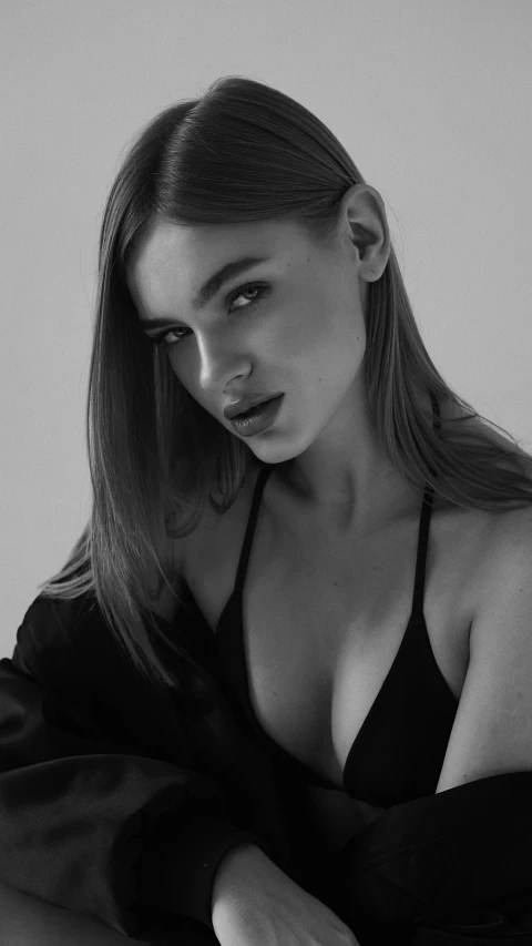 a black and white photo of a woman in a black dress, eva elfie, brown hair and a perfect body, gif, olya bossak