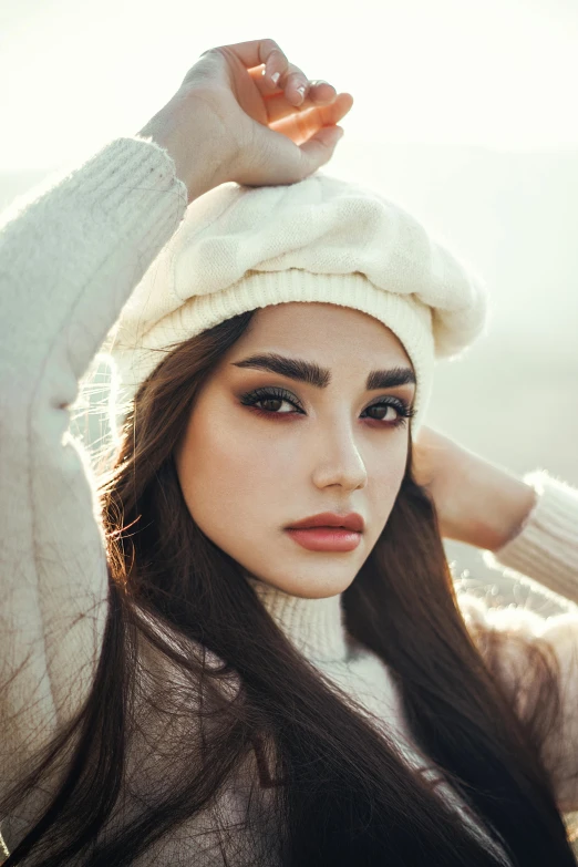 a woman with long hair wearing a white hat, a colorized photo, inspired by Elsa Bleda, trending on pexels, big bold thick eyebrows, wearing casual sweater, beautiful arab woman, 5 0 0 px models