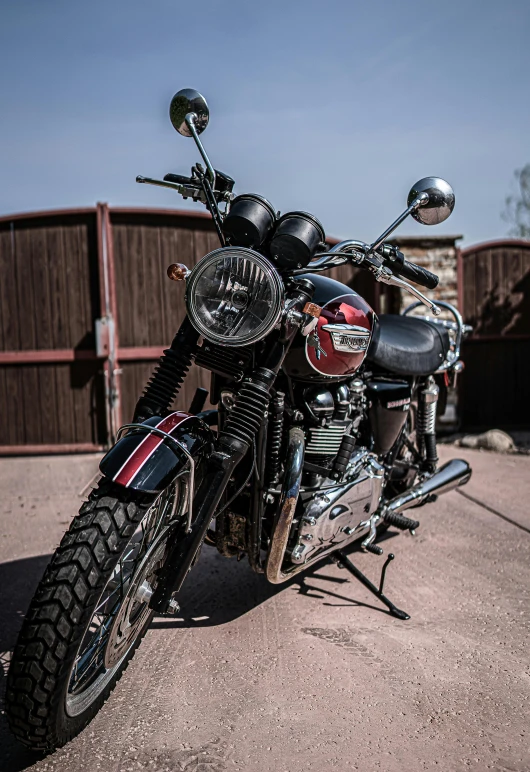 a motorcycle parked in front of a wooden fence, pexels contest winner, photorealism, silver red white details, triumph, hindu, front flash