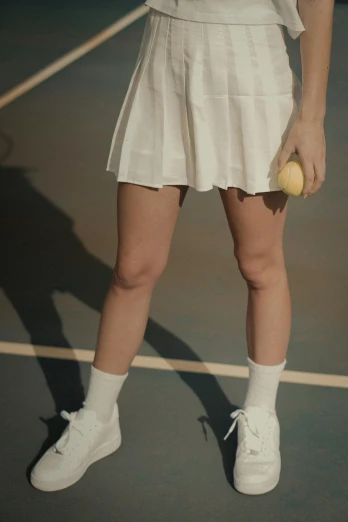 a woman holding a tennis racquet on a tennis court, an album cover, by Ellen Gallagher, trending on pexels, white miniskirt, vhs footage still, white shoes, ( ( theatrical ) )