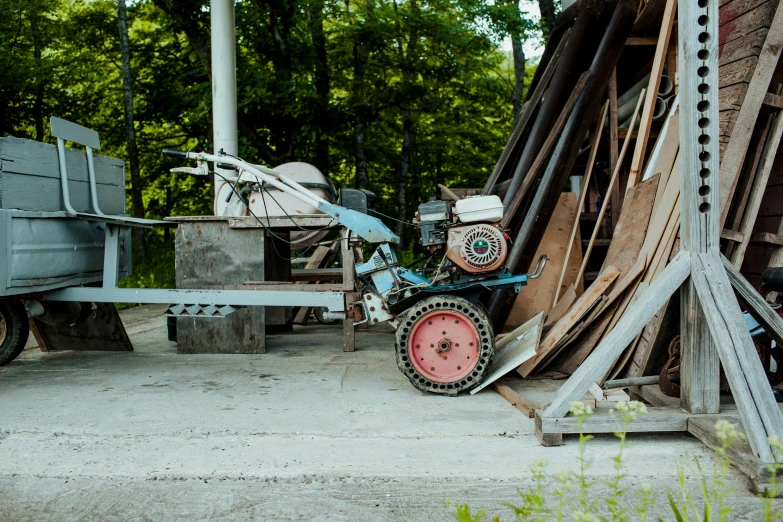 a tractor parked next to a pile of wood, unsplash, mingei, portable generator, portrait n - 9, mill, ecovillage