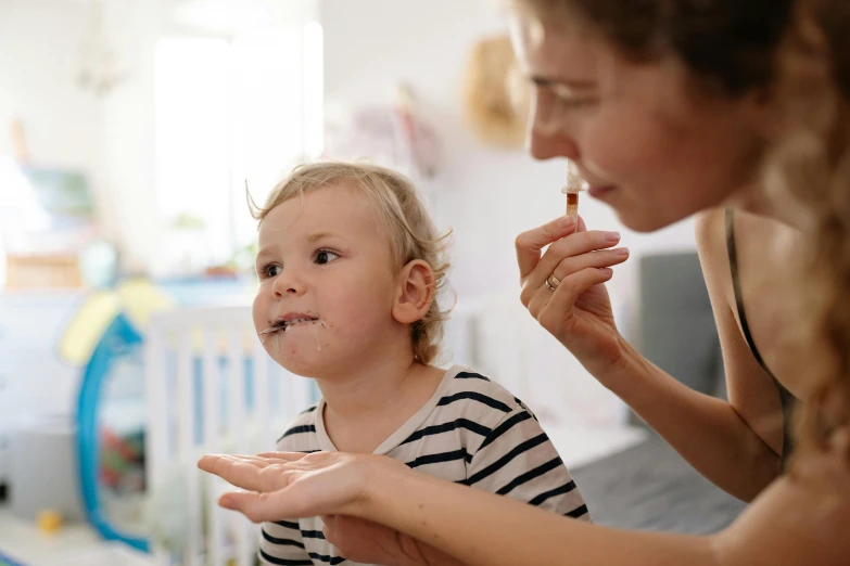 a woman brushing a child's teeth with a toothbrush, pexels contest winner, antipodeans, a plaster on her cheek, lachlan bailey, with wart, high quality topical render