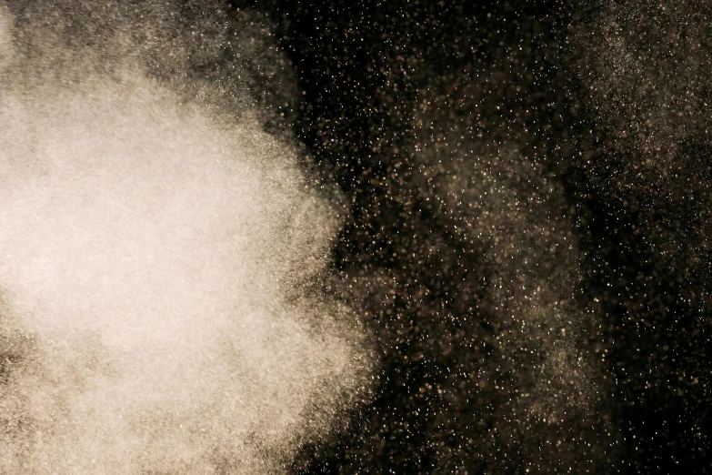 a man riding a snowboard down a snow covered slope, a stipple, inspired by Anna Füssli, pexels, kinetic pointillism, detailed smoke and dust, close up of single sugar crystal, gradient brown to white, on a black background