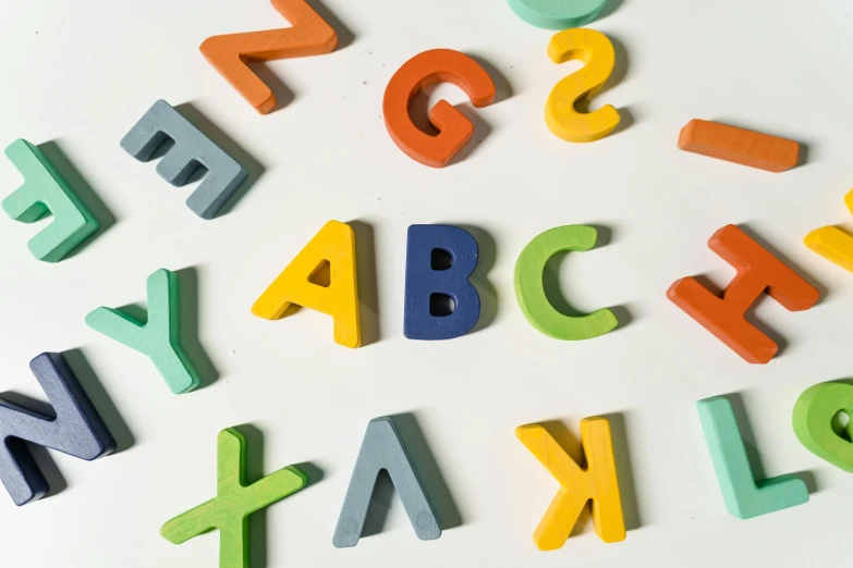 a group of wooden letters sitting on top of a white surface, multi colour, thumbnail, detail shot, multiple stories