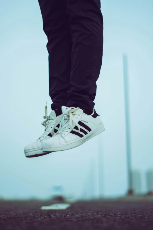 a man flying through the air while riding a skateboard, pexels contest winner, happening, sneaker shoes, standing on the mast, an all white human, wearing adidas clothing