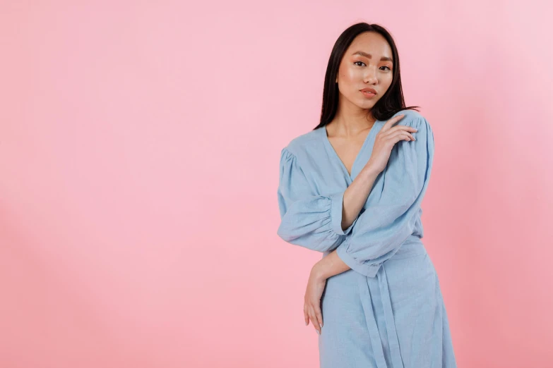 a woman in a blue dress posing for a picture, inspired by Jean-Étienne Liotard, pexels contest winner, happening, minimal pink palette, yukata clothing, double denim, background image