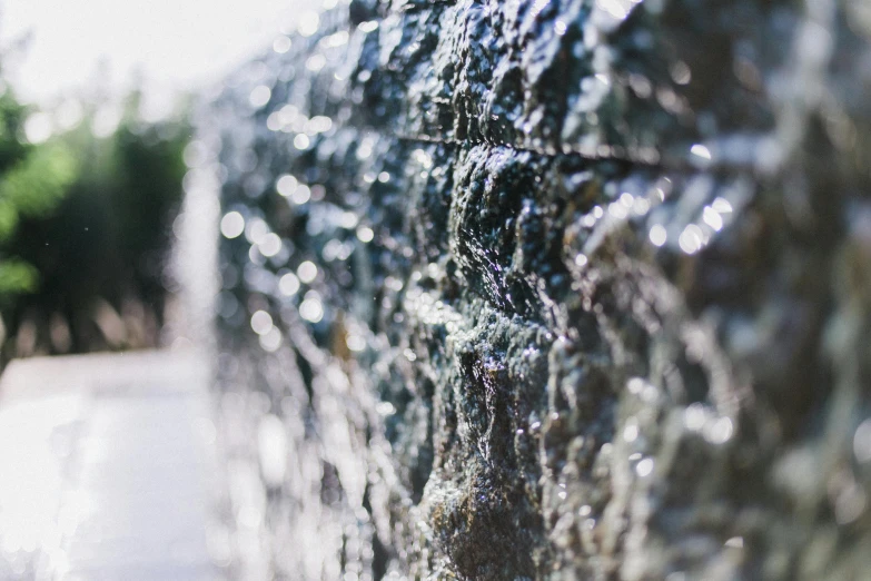 a close up of a fire hydrant with water coming out of it, by Cherryl Fountain, unsplash, waterfall walls, shiny silver, unfocused, shot on sony a 7