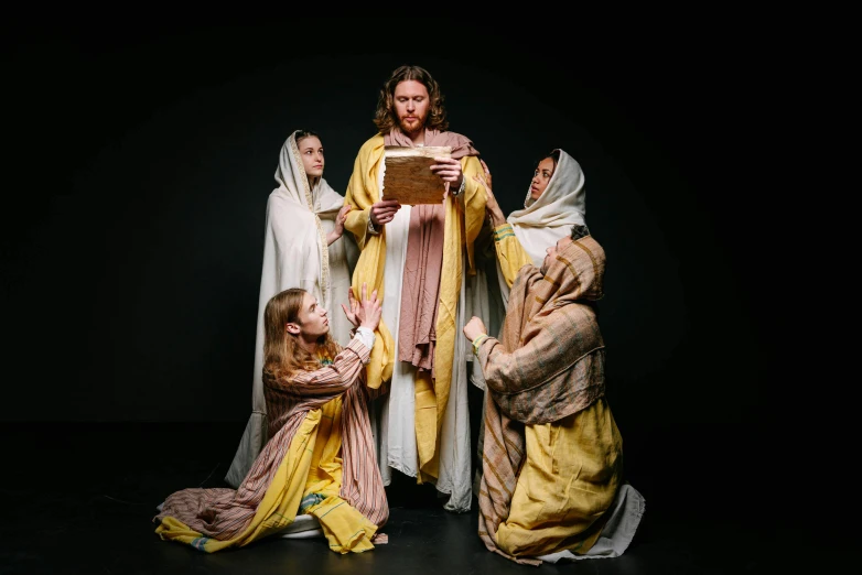 a group of people dressed as jesus and mary, an album cover, inspired by Geertgen tot Sint Jans, pexels, [ theatrical ], studio lit, children's, clothed in ancient