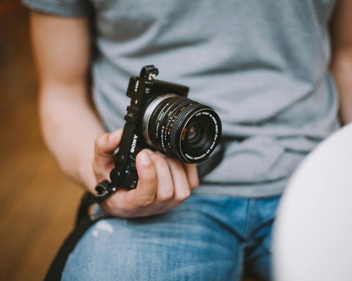 a close up of a person holding a camera, pexels contest winner, casually dressed, short dof, [ realistic photography ], 35mm of a very cute