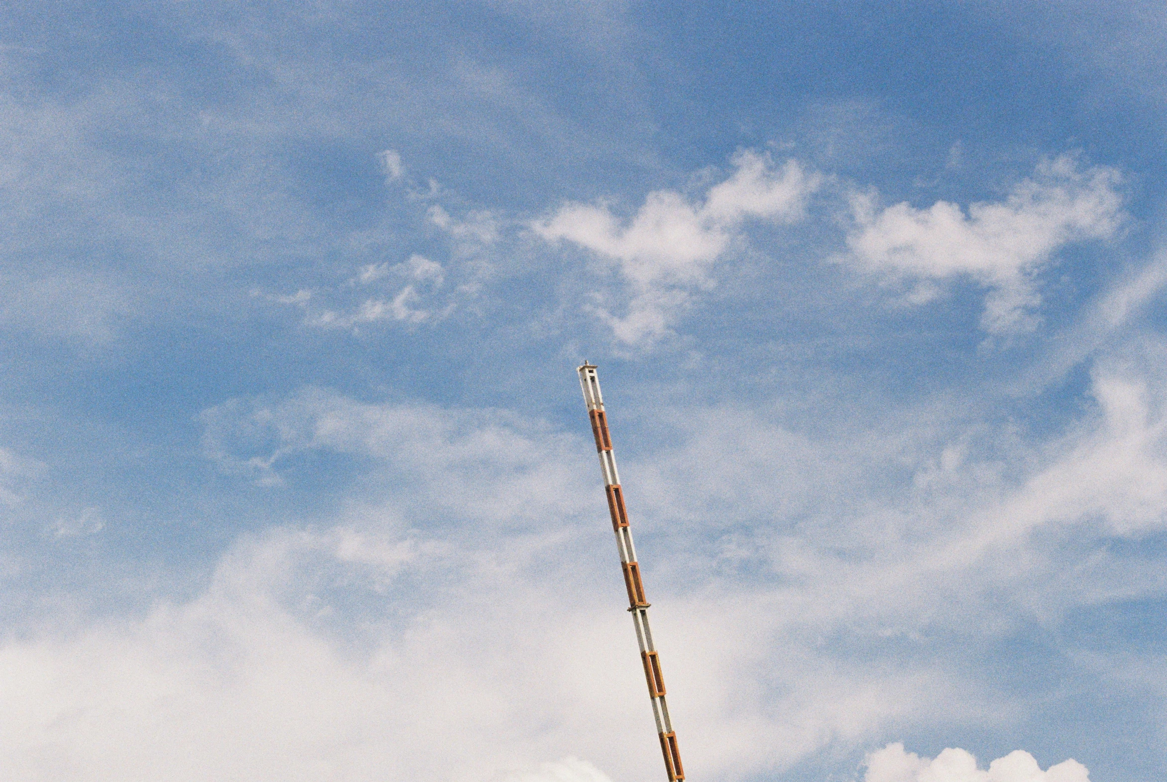 a man flying a kite on top of a lush green field, unsplash, postminimalism, telephone pole, on clouds, flat metal antenna, 35 mm photo