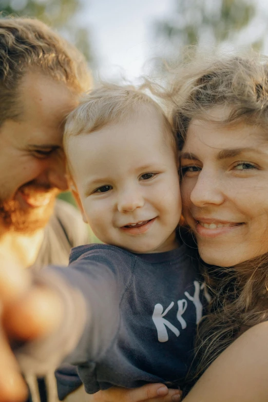 a man and woman taking a selfie with a baby, a picture, pexels contest winner, happy kid, square, 256435456k film, beautiful natural soft light