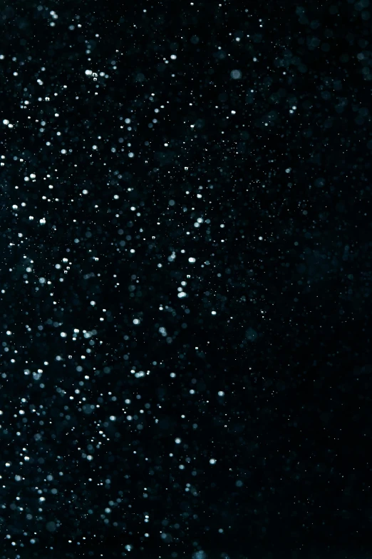 a man riding a snowboard down a snow covered slope, an album cover, pexels, light and space, black tar particles, glitter gif, interstellar night, grainy footage