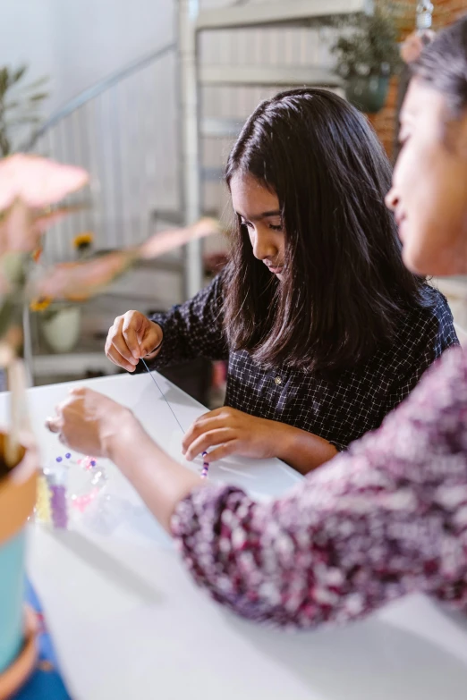 a couple of women that are sitting at a table, a child's drawing, pexels contest winner, process art, dotting, glass paint, intricated design, loosely cropped