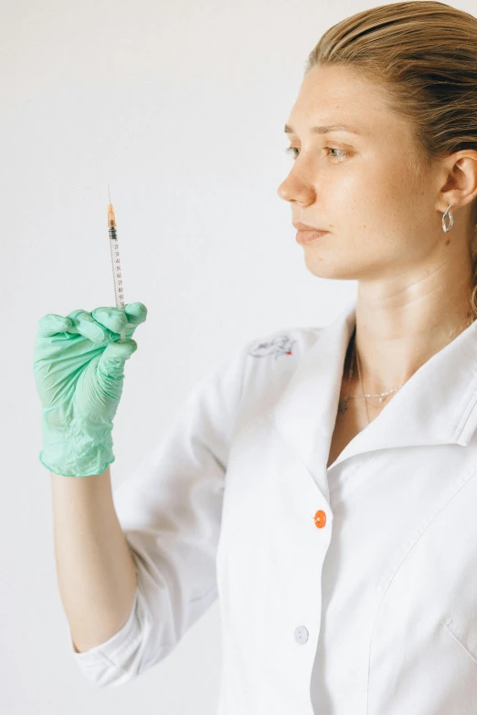 a woman in a lab coat holding a needle, a colorized photo, shutterstock, ilustration, russian academic, sculpting, resin