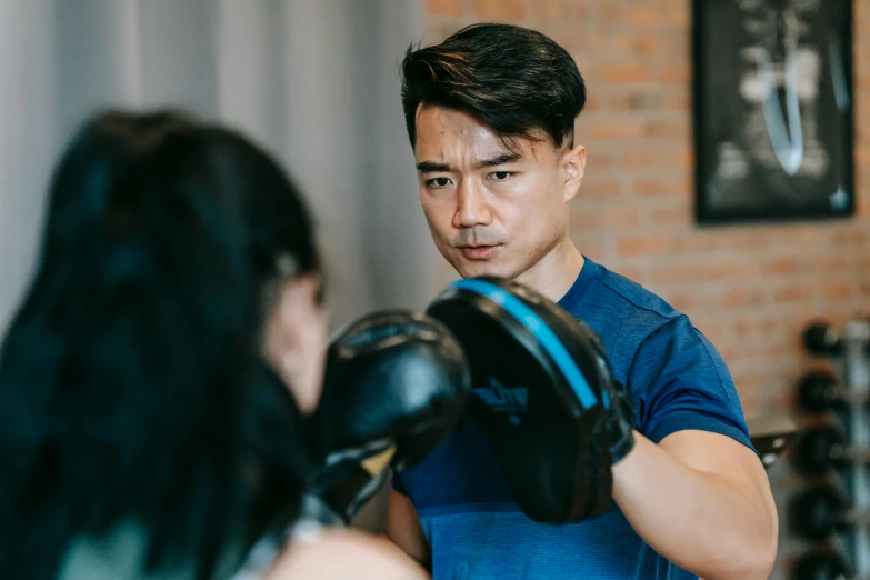 a man standing next to a woman in a boxing ring, inspired by Ma Quan, happening, central hub, profile image