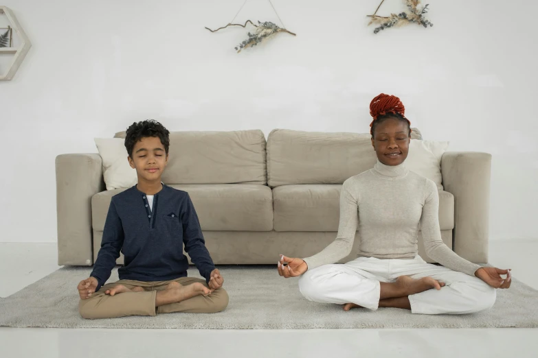 a woman and a boy sitting on a rug in front of a couch, pexels contest winner, hurufiyya, meditating pose, high rendering, riyahd cassiem, health spa and meditation center