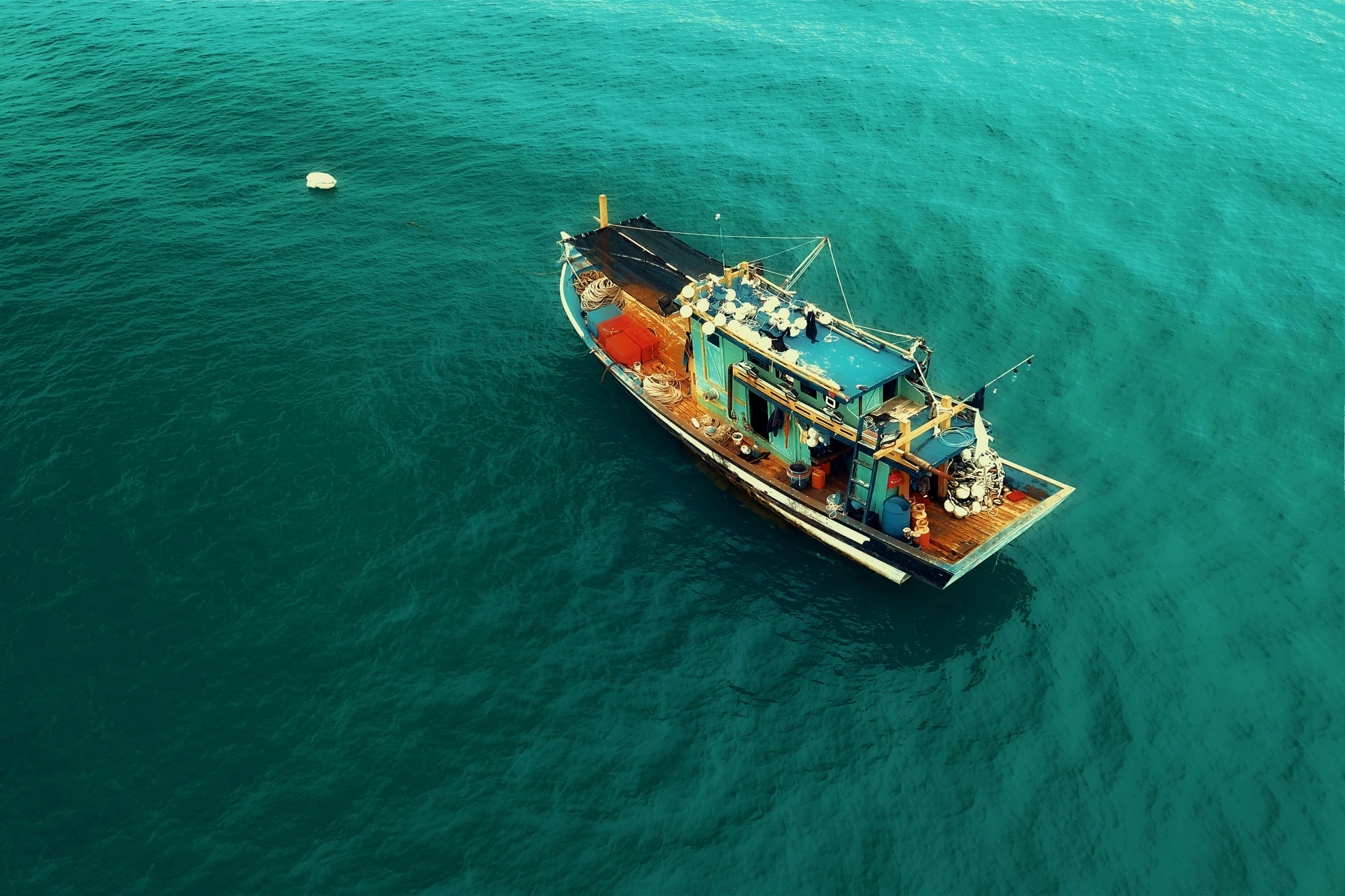 a boat floating in the middle of the ocean, pexels contest winner, hurufiyya, mining, profile pic, manly, dredged seabed