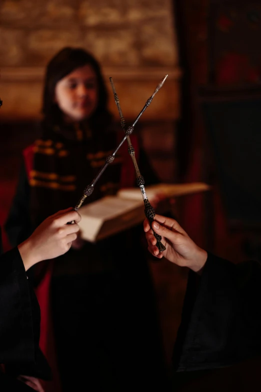 a close up of a person holding a pair of scissors, academic art, hogwarts great hall, wielding a magic staff, friends, promo image