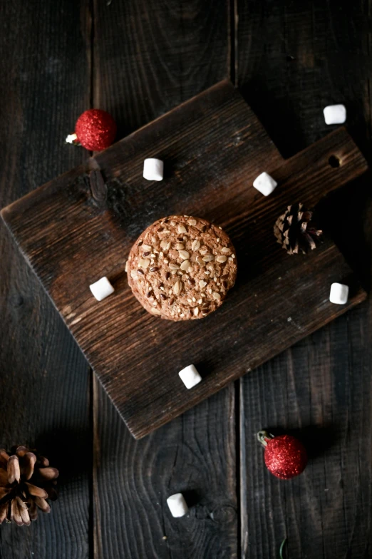 a cookie sitting on top of a wooden cutting board, profile image, rocky roads, thumbnail, flat lay