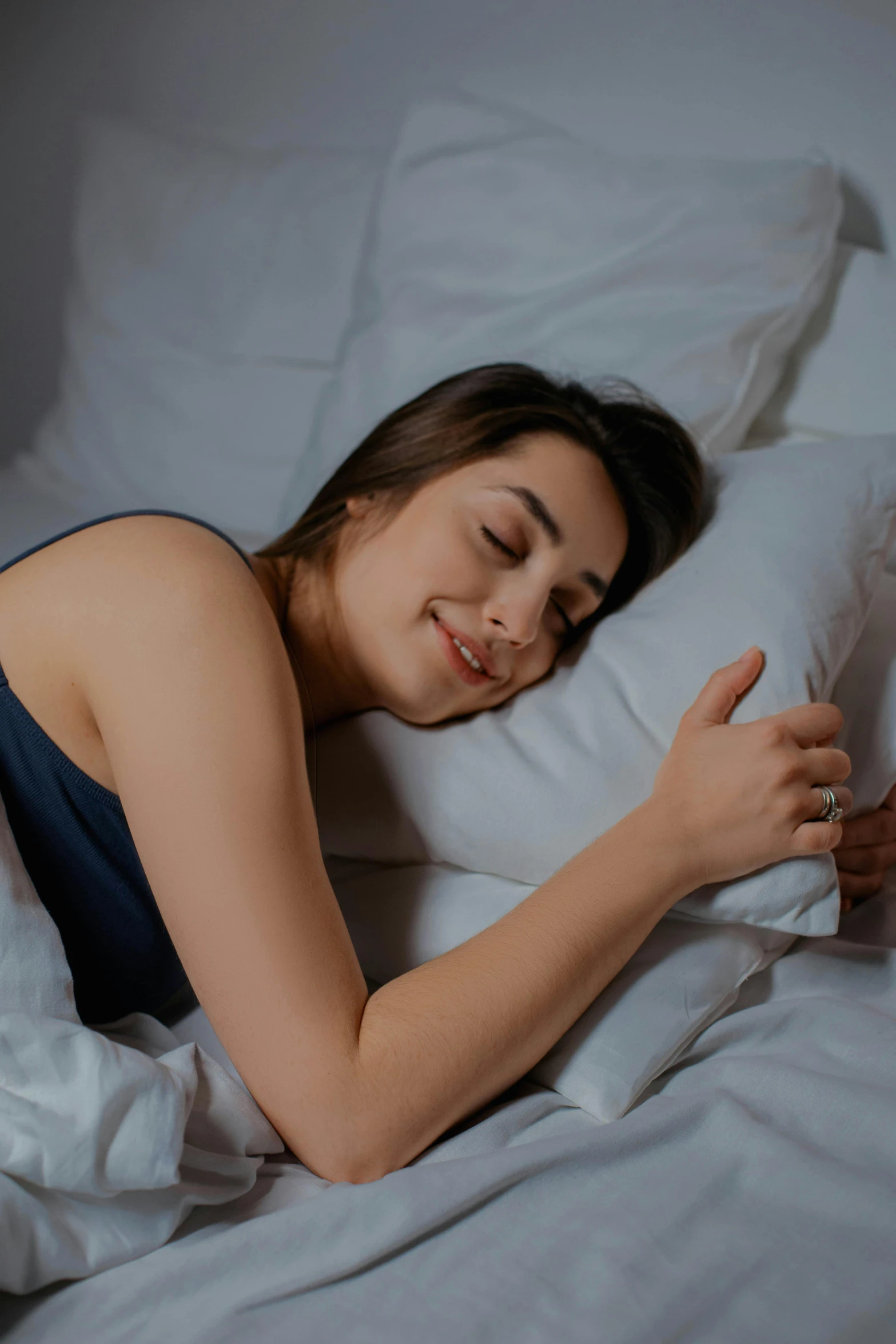 a woman laying in bed with her eyes closed, pexels contest winner, smiling slightly, bed on the right, nights, profile image