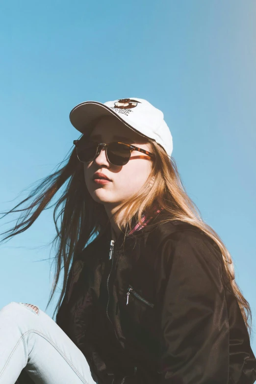 a woman sitting on top of a grass covered field, wearing sunglasses and a cap, discord profile picture, sydney sweeney, profile image