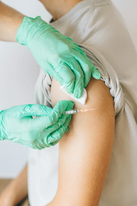 a person in a white shirt and green gloves, a picture, shutterstock, holding syringe, from the elbow, round thighs, thumbnail