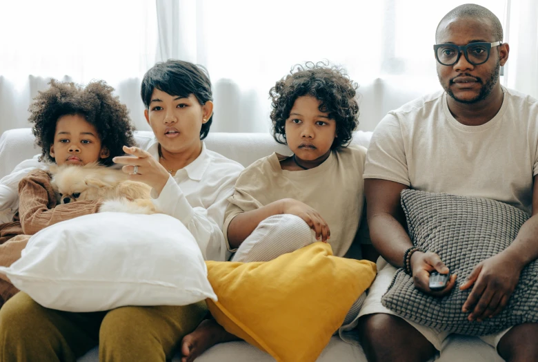 a group of people sitting on top of a couch, pexels, children's tv show, husband wife and son, avatar image, mixed race