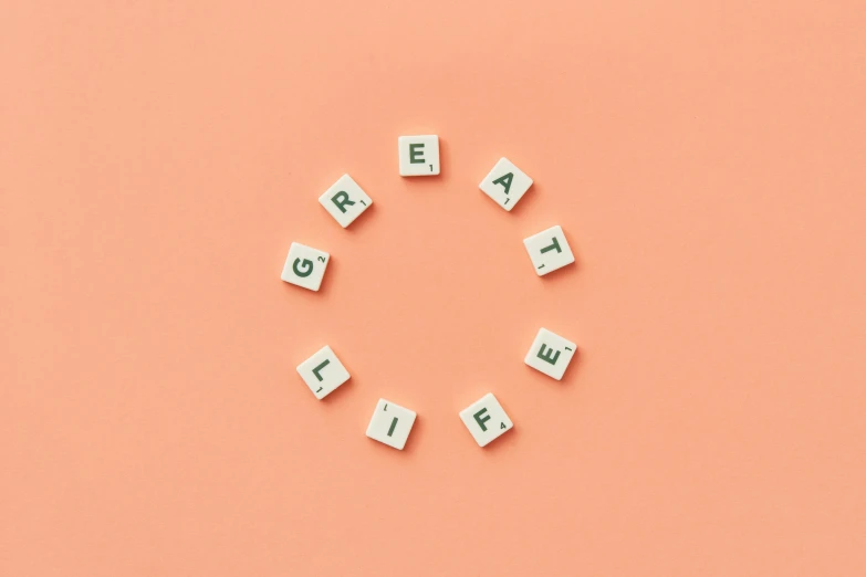 the word great is spelled in scrabbles on an orange background, by Emma Andijewska, trending on pexels, aestheticism, in a circle, life cycle, knolling, on a pale background