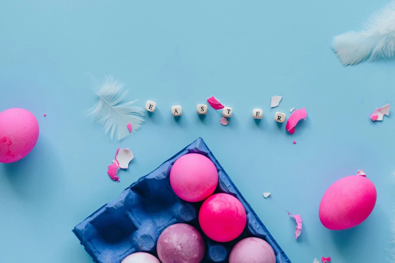 a blue carton filled with pink and white eggs, an album cover, trending on pexels, feathers, floating pieces, background image, candy decorations