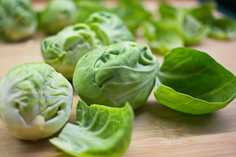 a close up of brussels sprouts on a cutting board, by Jessie Algie, shutterstock, fan favorite, fresh basil, 6 pack, panels