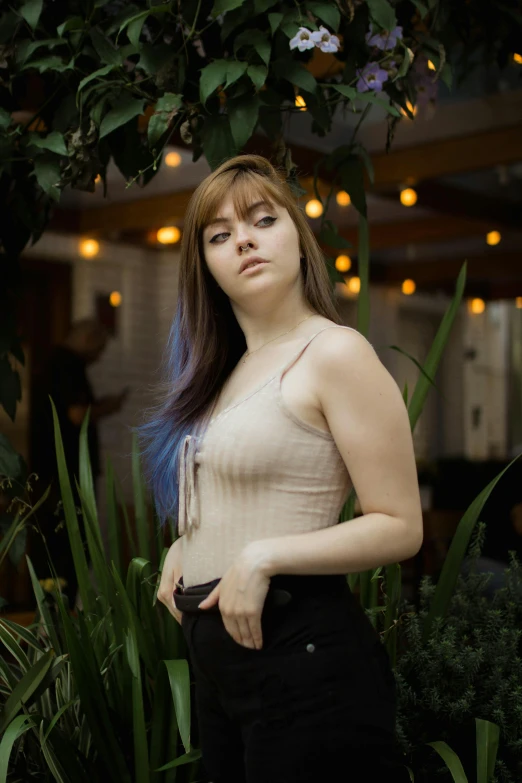 a woman standing in front of a tree, an album cover, inspired by Elsa Bleda, pexels contest winner, renaissance, standing in a restaurant, wearing tank top, brown hair and bangs, better known as amouranth