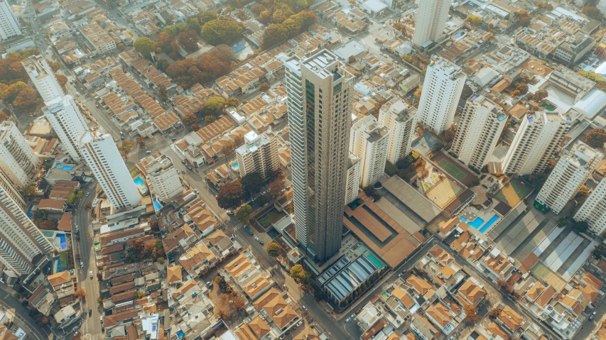 an aerial view of a city with tall buildings, by Luis Miranda, pexels contest winner, modernism, sri lanka, brown, single building, rem koolhaas