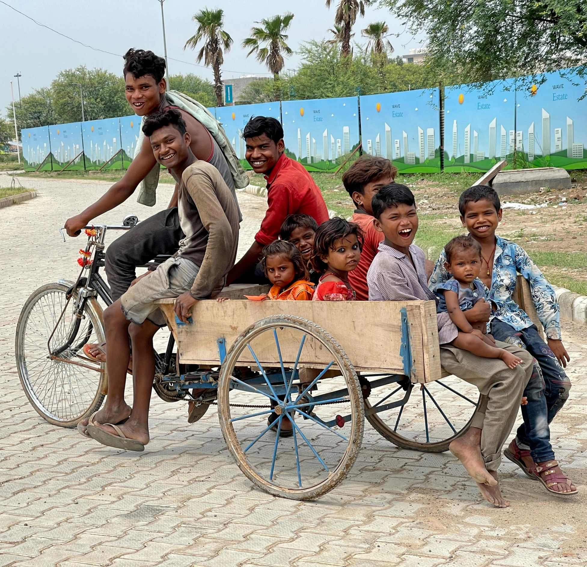 a group of people riding on the back of a bike, by Benjamin Block, pexels contest winner, samikshavad, square, cart, cute boys, unedited