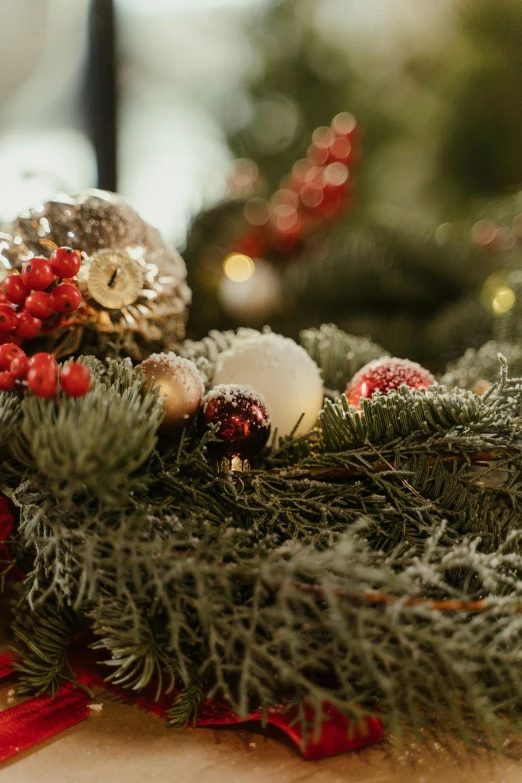 a close up of a christmas wreath on a table, by Adam Marczyński, soft grey and red natural light, filigree ornaments, multiple lights, medium close up