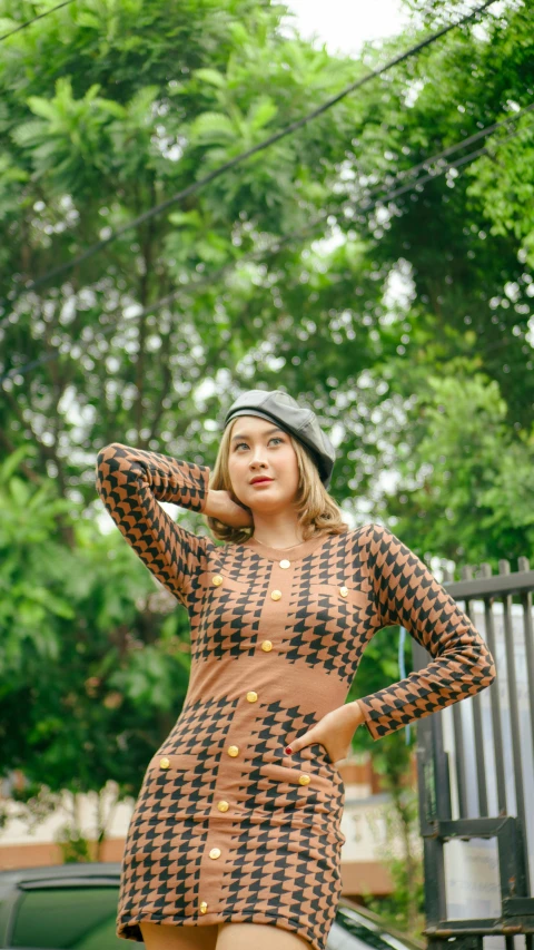 a woman in a plaid dress posing for a picture, inspired by Nyuju Stumpy Brown, trending on pexels, op art, kuntilanak, brown sweater, 15081959 21121991 01012000 4k, batik