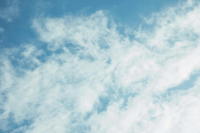 a large jetliner flying through a cloudy blue sky, an album cover, by Carey Morris, pexels contest winner, minimalism, puffy cute clouds, a delicate, modeled, view from below