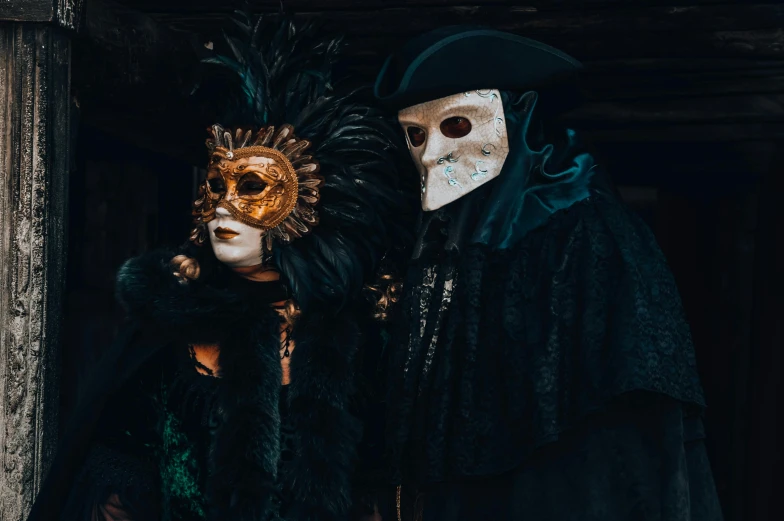 two people wearing masks standing next to each other, inspired by Hedi Xandt, pexels contest winner, baroque, murderous carnival freak, wearing a black robe, no watermarks, a group of people