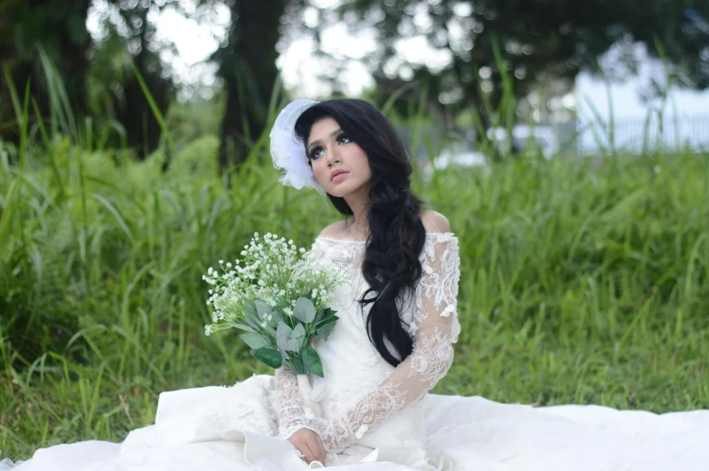 a woman in a wedding dress sitting in the grass, inspired by reyna rochin, sumatraism, portrait image, b - roll, cindy avelino, image