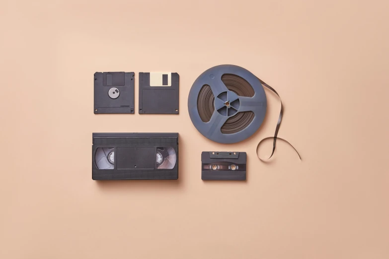 a couple of video tapes sitting on top of a table, unsplash, video art, various items, historical archive, flat lay, 1980s photo