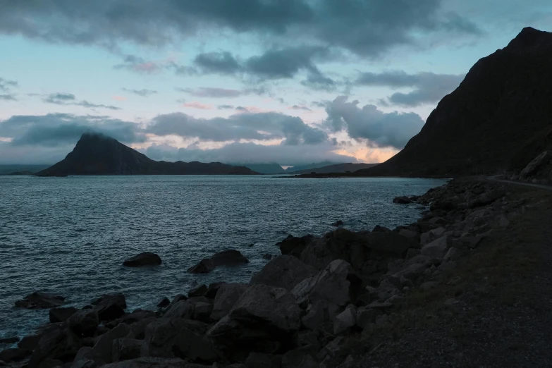 a body of water with a mountain in the background, by Hallsteinn Sigurðsson, pexels contest winner, hurufiyya, evening ambience, youtube thumbnail, grey, hammershøi